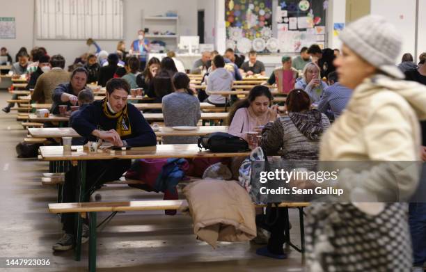 Refugees from Ukraine receive food in a cafeteria at the refugees registration center at former Tegel airport on December 09, 2022 in Berlin,...
