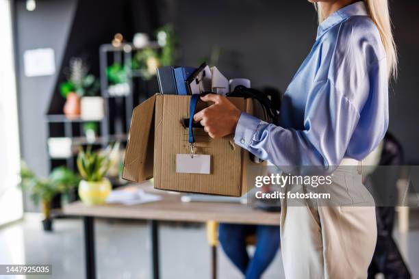 businesswoman holding a box with her belongings, looking for a new job - being fired photos stock pictures, royalty-free photos & images