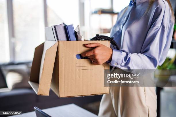 cut out shot of businesswoman holding a box with office supplies and her belongings after getting fired - being fired stock pictures, royalty-free photos & images