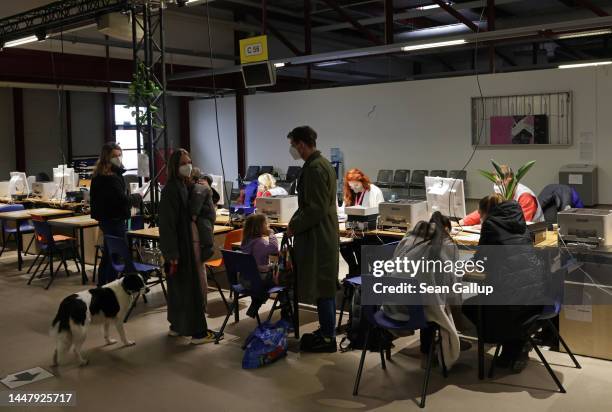 Newly-arrived refugees from Ukraine, including a family with a dog, undergo registration at a refugees welcome center at former Tegel airport on...