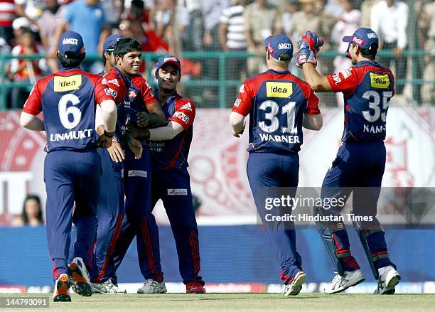 Delhi Daredevils player Umesh Yadav celebrates with teammates after the dismissal of Kings XI Punjab Batsman Adam Gilchrist during IPL 5 T20 cricket...