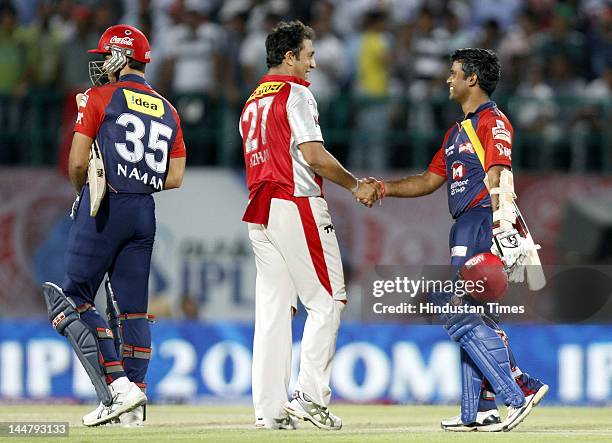 Kings XI Punjab bowler Azhar Mahmood congratulate Delhi Daredevils batsman Venu Gopal Rao and Naman Ojha on their victory in IPL 5 T20 cricket match...