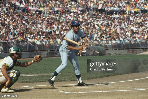 American baseball player Ray Fosse behind Puerto Rican baseball player Felix Millan during an 1973 World Series match between the Oakland Athletics...