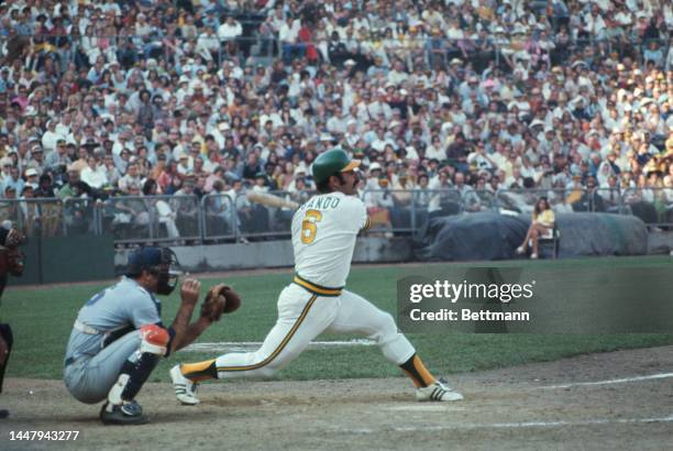 American baseball player Jerry Grote behind American baseball player Sal Bando during an 1973 World Series match between the Oakland Athletics and...