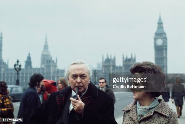 British politician Harold Wilson , leader of the Labour Party, smoking a pipe, with his wife, British poet Mary Wilson , campaigning during the...
