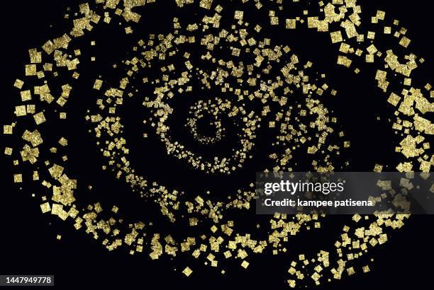 golden confetti on the black background - golden spiral stock pictures, royalty-free photos & images