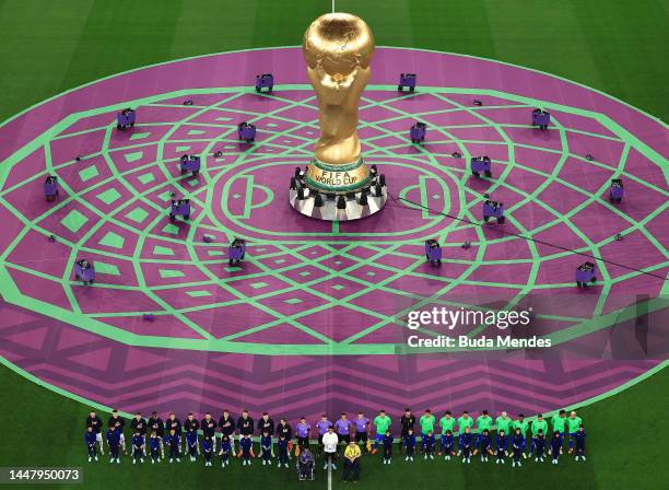 Pyrotechnics surround a giant FIFA World Cup trophy prior to the FIFA World Cup Qatar 2022 quarter final match between Croatia and Brazil at...