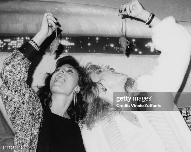 Jane Badler and June Chadwick pretending to eat mice at a party for the TV series "V" held at the Rainbow Room in New York City, New York, United...