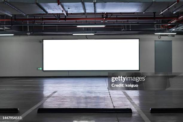 blank billboard in underground garage - billboard night stock pictures, royalty-free photos & images