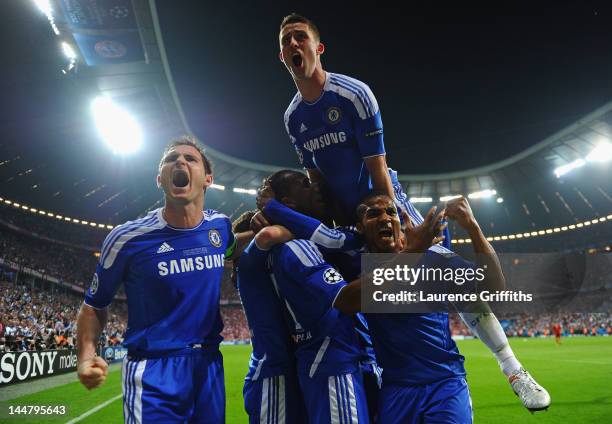 Didier Drogba of Chelsea celebrates with team mates Frank Lampard and Gary Cahill after scoring his team’s first goal during UEFA Champions League...