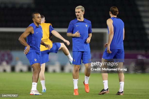 Jules Kounde and Antoine Griezmann of France train during the France Training Session Training Session at Al Saad SC on December 09, 2022 in Doha,...