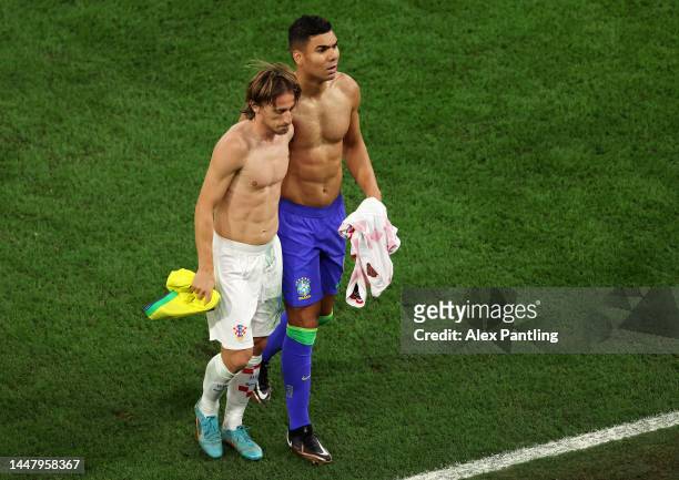 Luka Modric of Croatia and Casemiro of Brazil swap shirts at half time during the FIFA World Cup Qatar 2022 quarter final match between Croatia and...