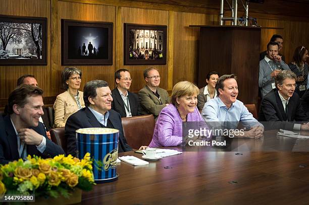 German Chancellor Angela Merkel, British Prime Minister David Cameron and EU Commission President Jose Manuel Barroso watch the UEFA Champions League...