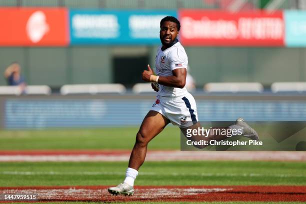 Marcus Tupuola of USA runs the ball for a try during the match between Canada and USA on day one of the HSBC World Rugby Sevens Series - Dubai at The...