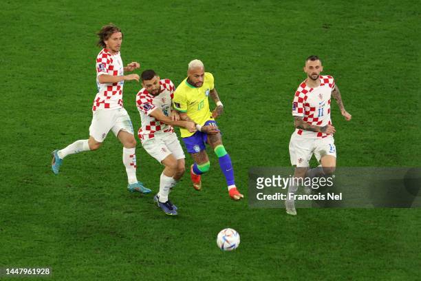 Neymar of Brazil competes for the ball against Mateo Kovacic, Marcelo Brozovic and Luka Modric of Croatia during the FIFA World Cup Qatar 2022...