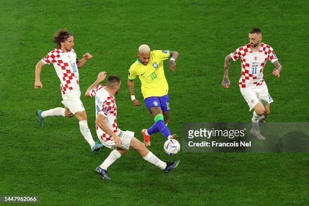Neymar of Brazil is challenged by Luka Modric, Mateo Kovacic and Marcelo Brozovic of Croatia during the FIFA World Cup Qatar 2022 quarter final match...