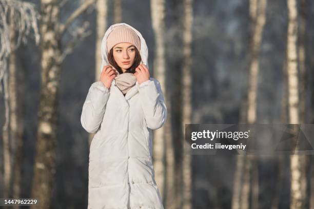 asian brunette woman in white jacket - hot korean women stock pictures, royalty-free photos & images