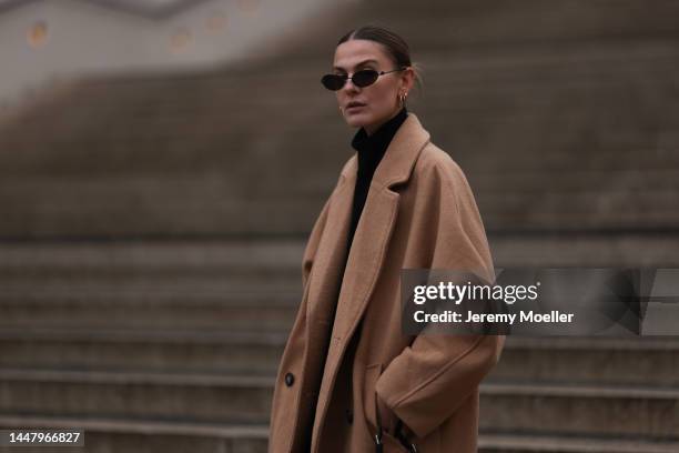 Alessa Winter is seen wearing Balenciaga black sunglasses, Edited black turtleneck knit sweater and Weekday beige/brown long wool coat, on December...