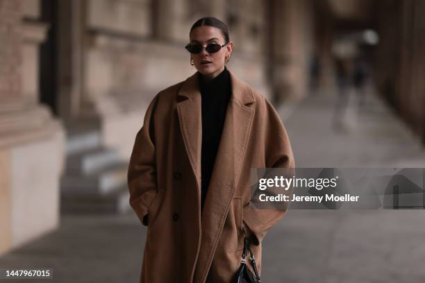 Alessa Winter is seen wearing Balenciaga black sunglasses, Edited black turtleneck knit sweater, Weekday beige/brown long wool coat, Balenciaga black...