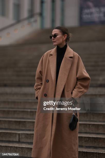 Alessa Winter is seen wearing Balenciaga black sunglasses, Edited black turtleneck knit sweater, Weekday beige/brown long wool coat, Balenciaga black...