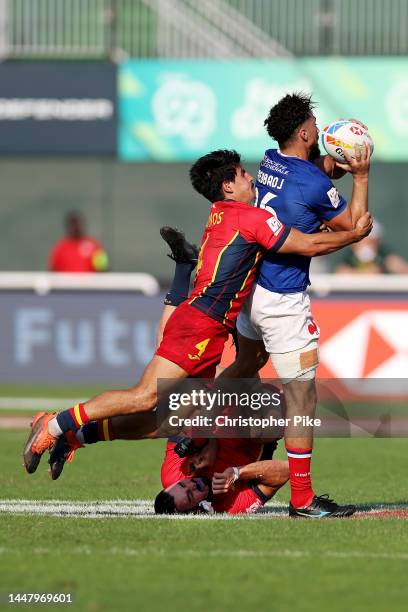 Rayan Rebbadj of France is tackled by Juan Ramos of Spain as teammate Tiago Romero is upended during the match between France and Spain on day one of...