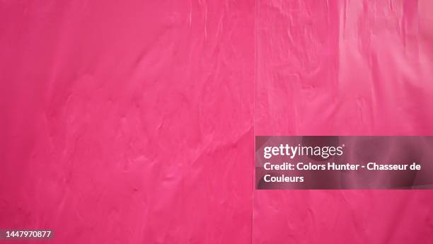 empty and clean pink posters stuck on a wall in paris - poster wall stock-fotos und bilder