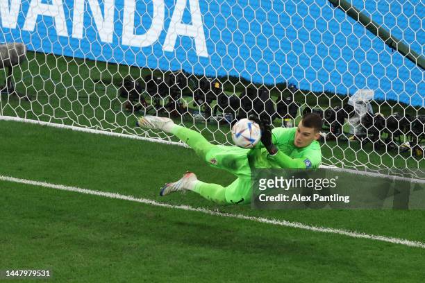 Dominik Livakovic of Croatia makes a save against Rodrygo of Brazil in the penalty shootout during the FIFA World Cup Qatar 2022 quarter final match...