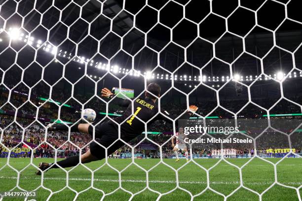 Lovro Majer of Croatia scores the team's second penalty past Alisson Becker of Brazil in the penalty shoot out during the FIFA World Cup Qatar 2022...