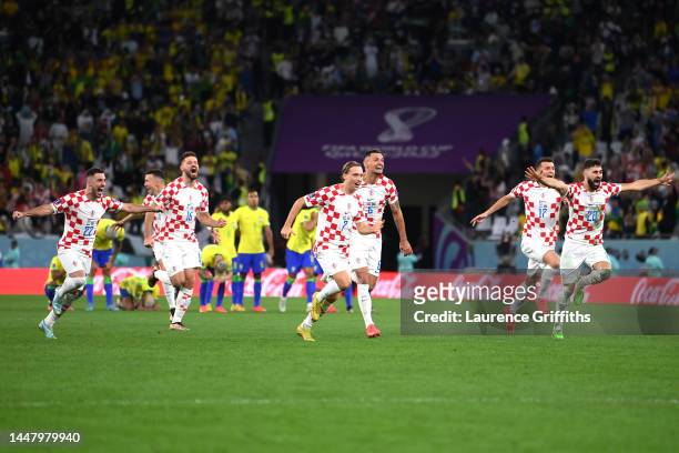 Croatia players celebrate their win via a penalty shootout during the FIFA World Cup Qatar 2022 quarter final match between Croatia and Brazil at...