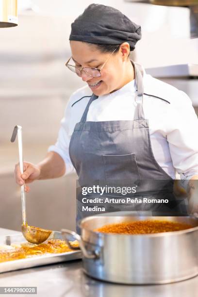 cook adding ingredients - woman chef stock pictures, royalty-free photos & images