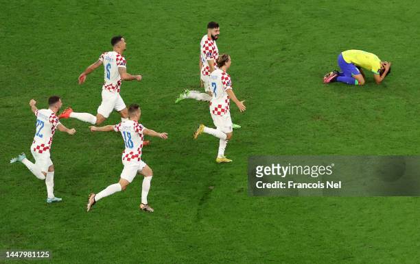 Croatia players celebrate after the team's victory in the penalty shoot out as Marquinhos of Brazil reacts during the FIFA World Cup Qatar 2022...