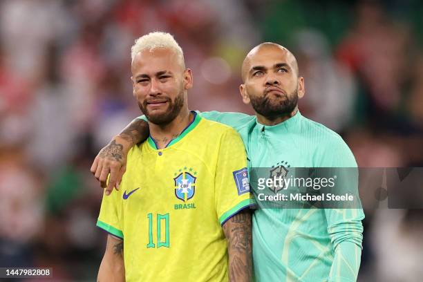Neymar and Dani Alves of Brazil look dejected after their sides' elimination from the tournament after a penalty shoot out loss during the FIFA World...