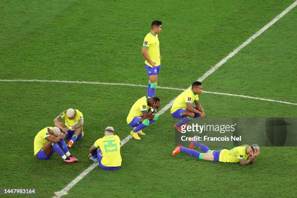 Brazil players Rodrygo, Pedro, Neymar, Antony, Fred, Casemiro and Alex Sandro react after the loss via a penalty shootout during the FIFA World Cup...