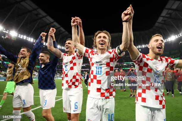 Dejan Lovren, Luka Modric and Nikola Vlasic of Croatia celebrate after the team's victory in the penalty shoot out during the FIFA World Cup Qatar...