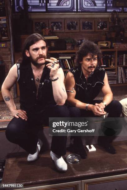 View of British Heavy Metal musicians Lemmy Kilmister and Phil 'Philthy Animal' Taylor , of the band Motorhead, as they sit on a low stage during an...