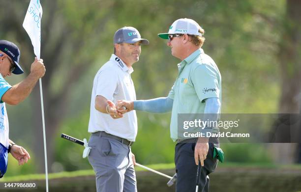 Charley Hoffman and Ryan Palmer of The United States celebrate another birdie on the ninth green during the first round of the QBE Shootout at...
