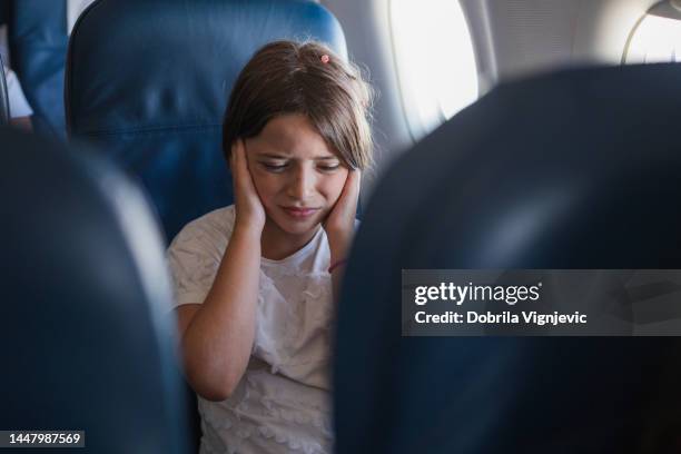 child crying due to earache during a plane flight - kid flying stock pictures, royalty-free photos & images