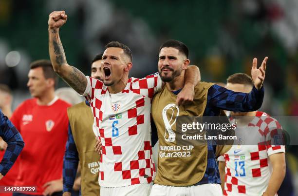Dejan Lovren and Martin Erlic of Croatia celebrate after the team's victory in the penalty shoot out during the FIFA World Cup Qatar 2022 quarter...