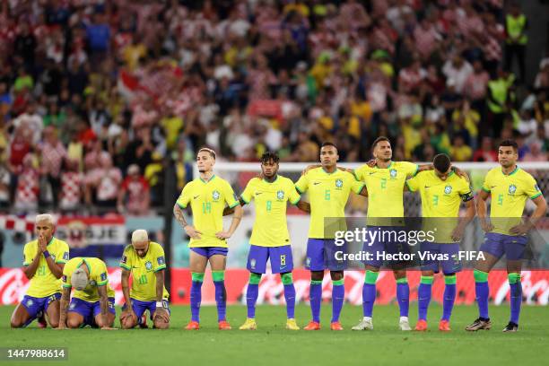 Brazil players show dejection after the team's defeat through the penalty shootout during the FIFA World Cup Qatar 2022 quarter final match between...