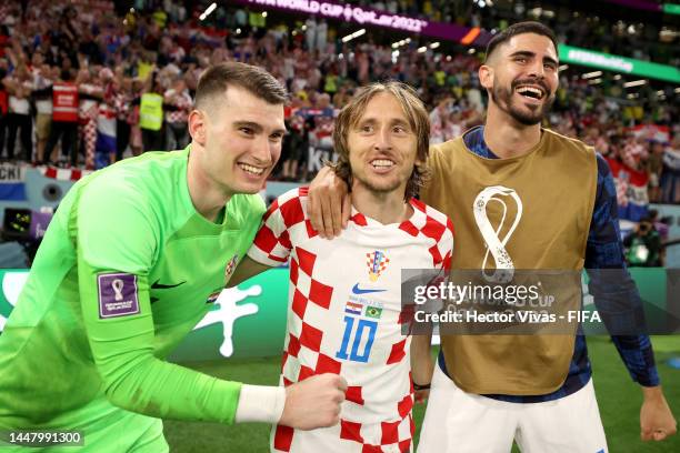 Dominik Livakovic, Luka Modric and Josip Sutalo of Croatia celebrate after the win via a penalty shootout during the FIFA World Cup Qatar 2022...