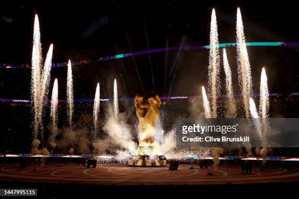 Pyrotechnics explode around a giant World Cup trophy prior to the FIFA World Cup Qatar 2022 quarter final match between Netherlands and Argentina at...