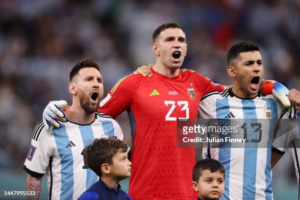 Lionel Messi, Emiliano Martinez and Cristian Romero of Argentina line up for the national anthem prior to the FIFA World Cup Qatar 2022 quarter final...