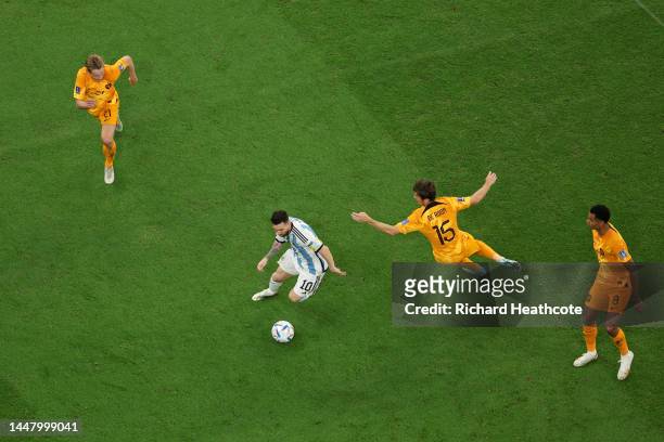 Lionel Messi of Argentina goes past Marten de Roon of Netherlands during the FIFA World Cup Qatar 2022 quarter final match between Netherlands and...