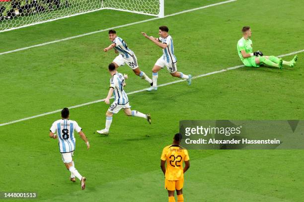 Nahuel Molina of Argentina celebrates with teammates after scoring the team's first goal during the FIFA World Cup Qatar 2022 quarter final match...