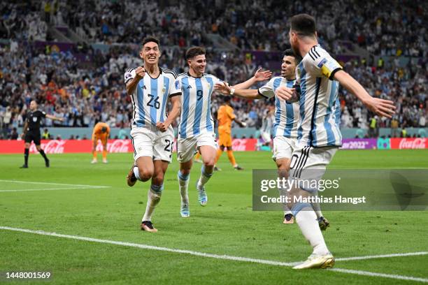 Nahuel Molina celebrates with Lionel Messi of Argentina after scoring the team's first goal during the FIFA World Cup Qatar 2022 quarter final match...