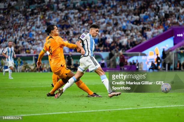 Nahuel Molina of Argentinia scores his team's first goal against Virgil van Dijk of Netherlands during the FIFA World Cup Qatar 2022 quarter final...
