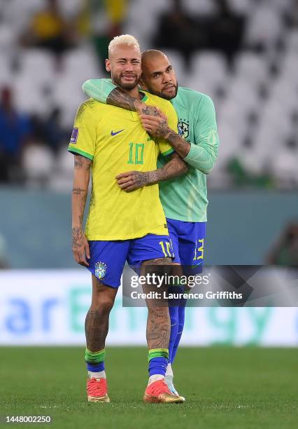 Neymar of Brazil is consoled by Dani Alves after the loss via a penalty shootout during the FIFA World Cup Qatar 2022 quarter final match between...