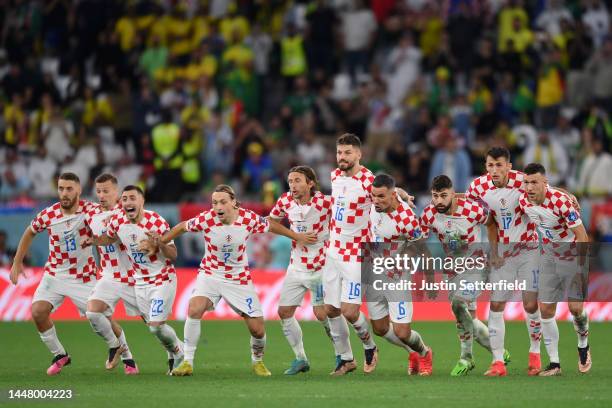 Croatia players celebrate their win via a penalty shootout during the FIFA World Cup Qatar 2022 quarter final match between Croatia and Brazil at...