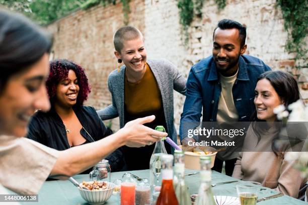 happy friends spending leisure time with each other at garden party in back yard - young women group back stock-fotos und bilder