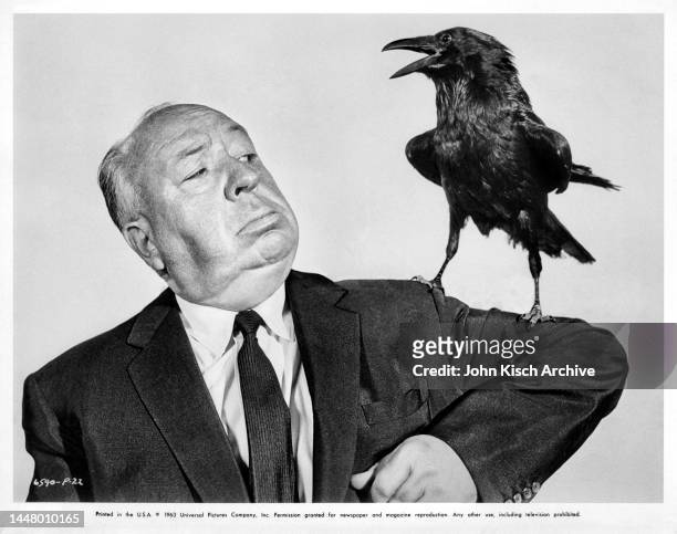 Publicity still of English-born film director Alfred Hitchcock, a crow on his arm, to promote his film 'The Birds,' 1963.